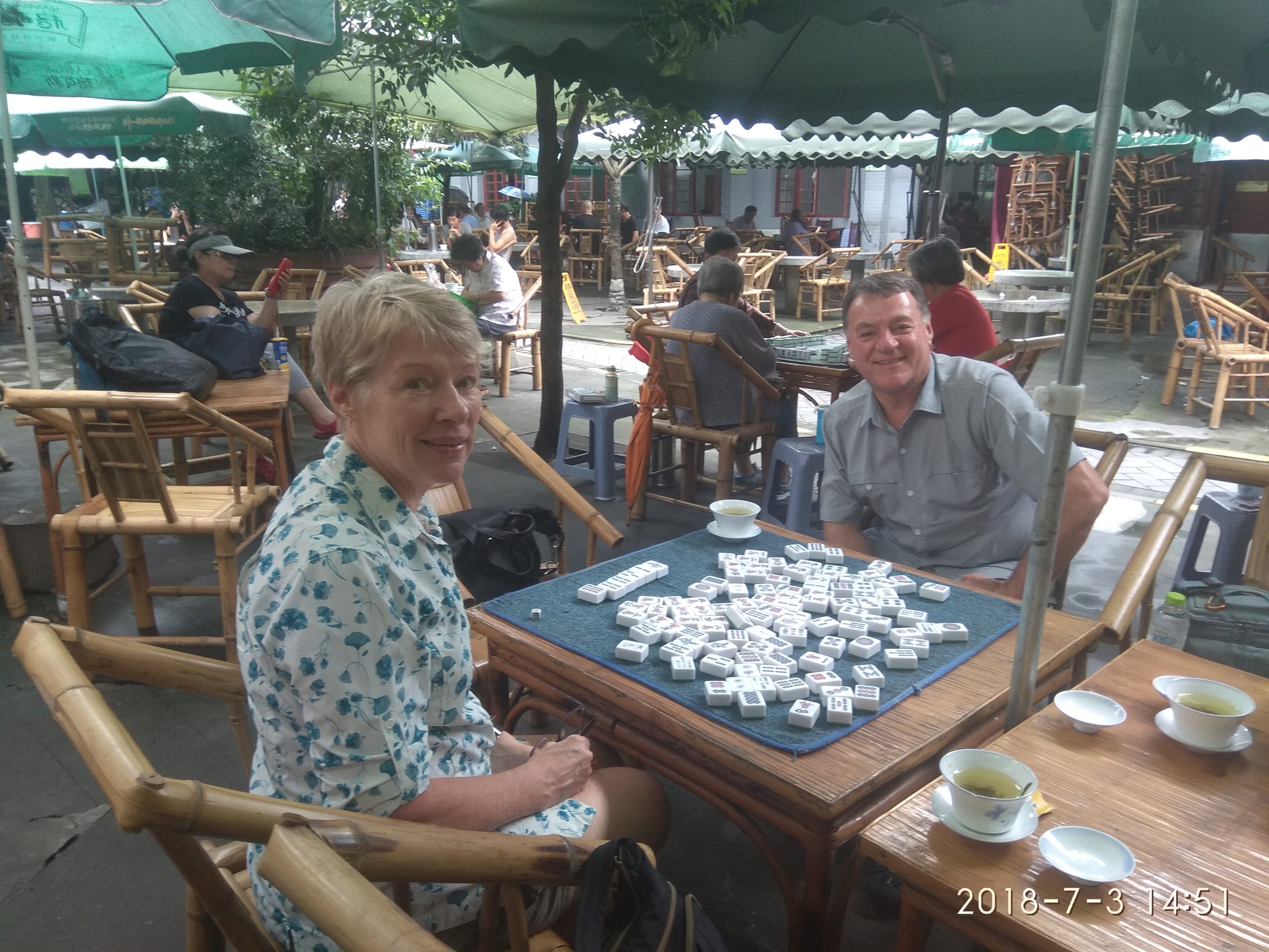 WindhorseTour guide teaching travelers how to play mahjong at People’s Park in Chengdu, China